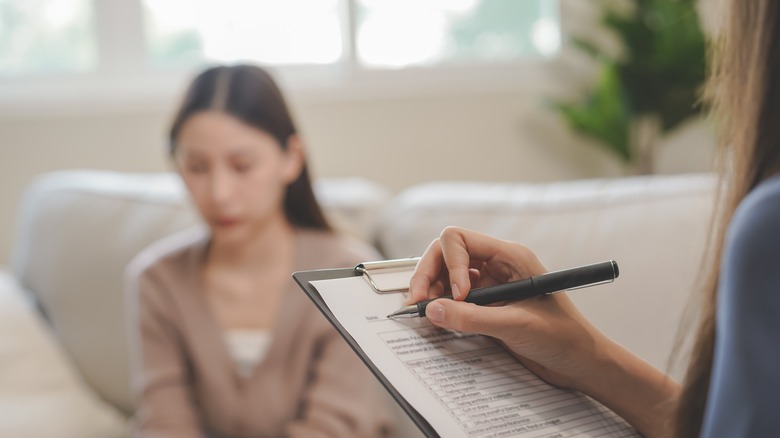 Doctor writing on clip board