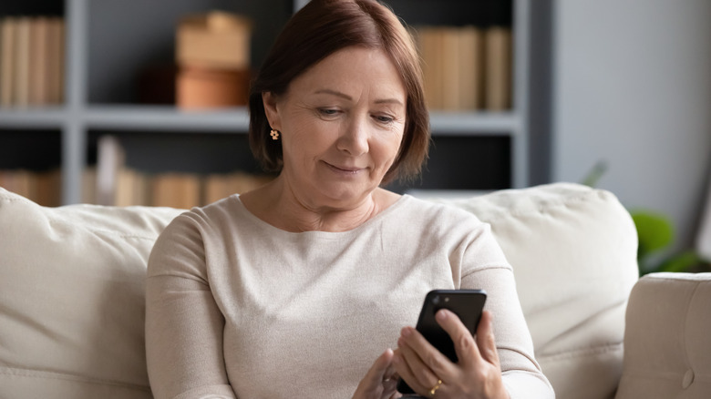 older woman looking at her phone