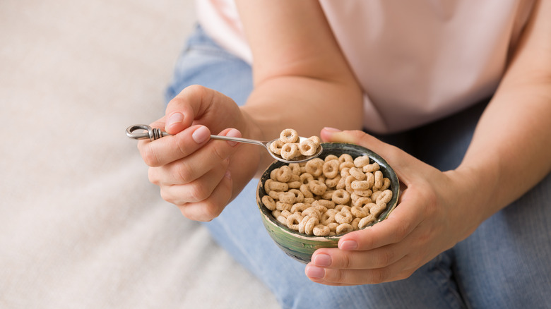 Woman eating Cheerios