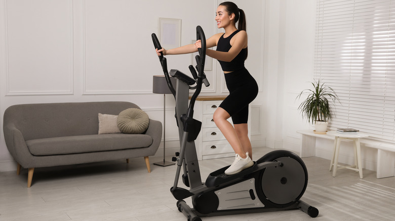 Fit woman using an elliptical trainer