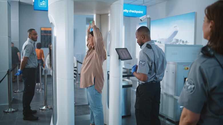 woman inside TSA body scanner