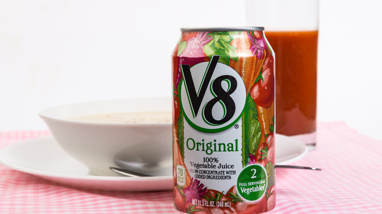 can of V8 juice next to a glass of V8 juice