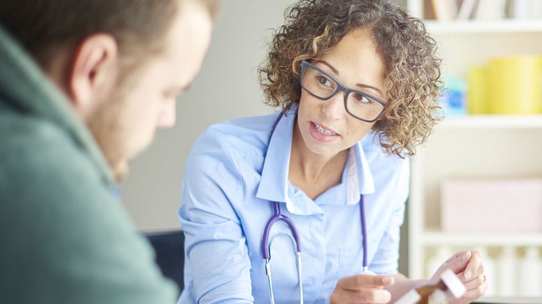 man at appointment with female doctor