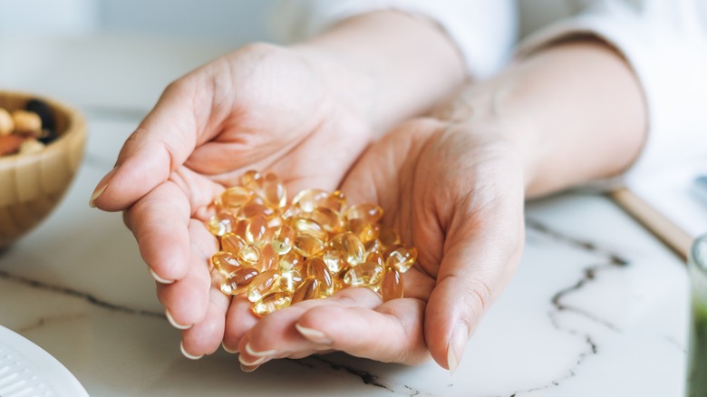 Woman holding vitamins