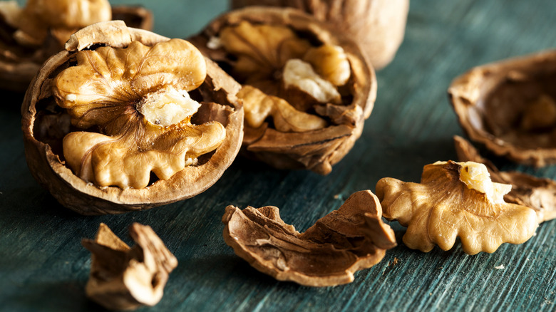 Cracked walnuts on wooden table