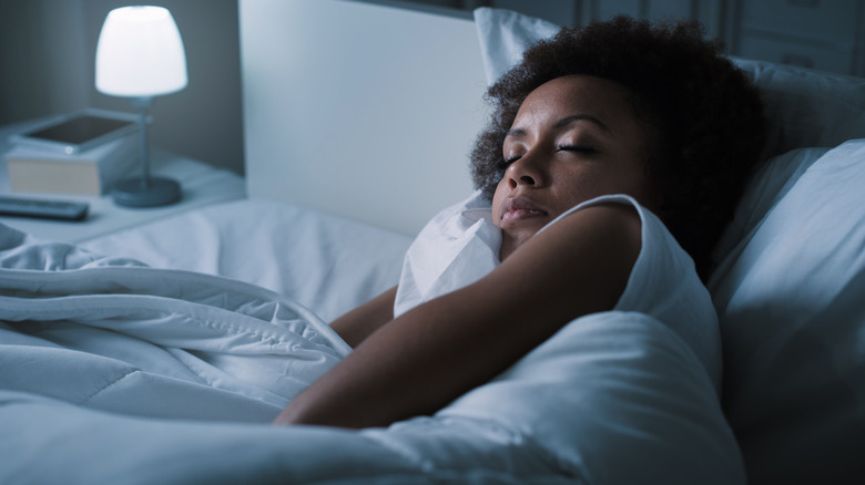 Young woman sleeping in bed