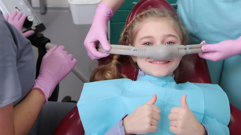 Girl smiling when receiving anesthesia