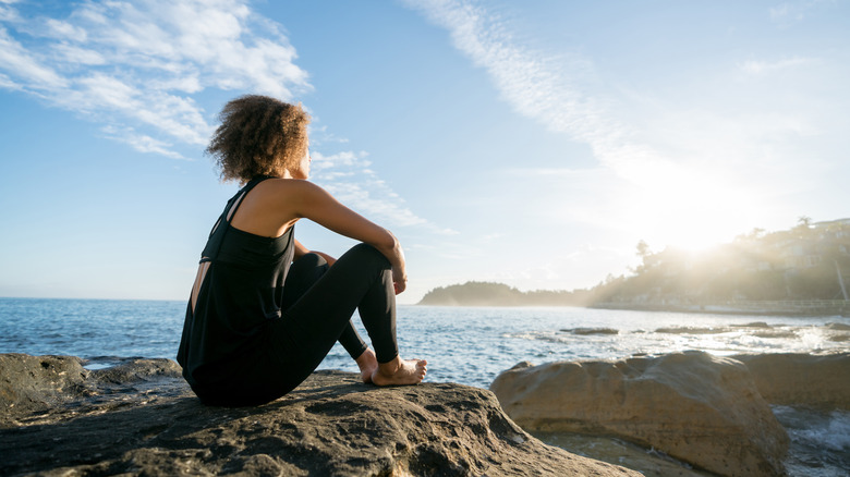 woman looking wistfully at ocean