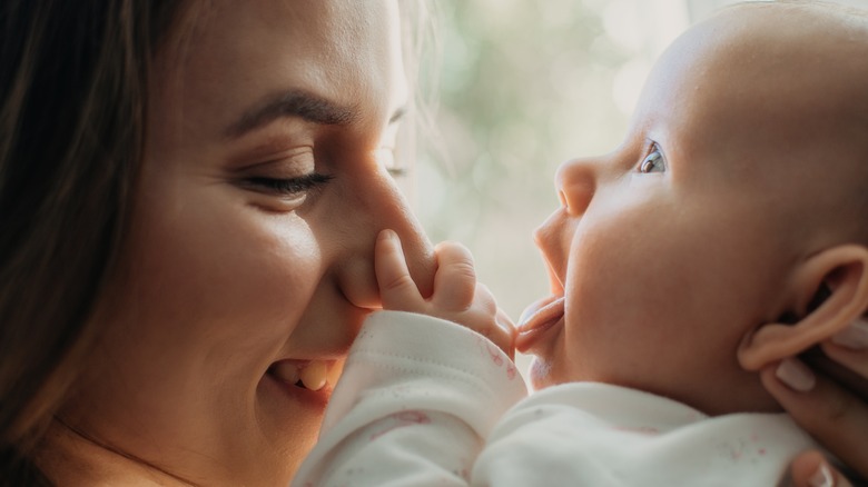 mom smiling at her baby