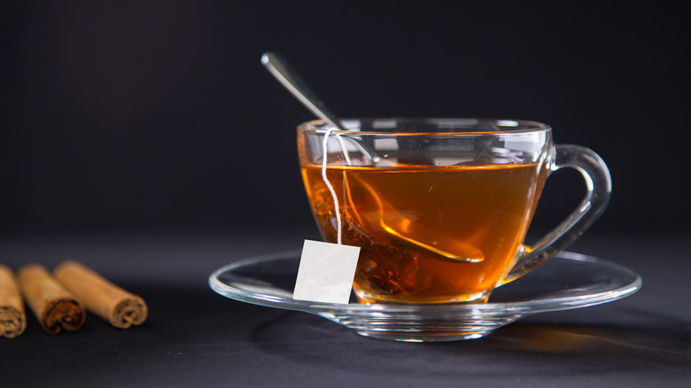 Transparent cup of tea steeping