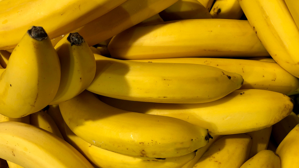 A close up view of bananas still in their peel 