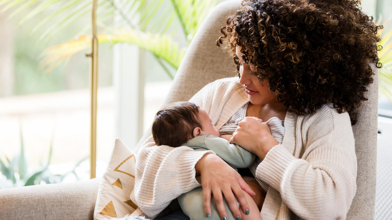 A woman breastfeeding at home