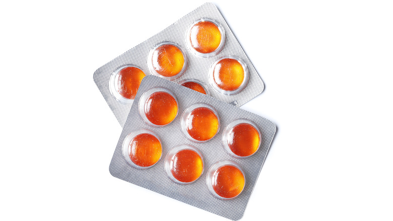 Packages of honey colored cough drops 
