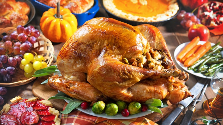 Roasted turkey and Thanksgiving side dishes on a table