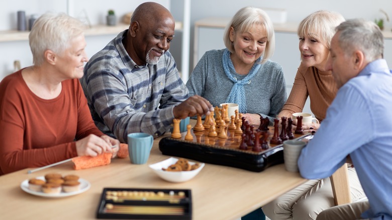 elderly people playing chess