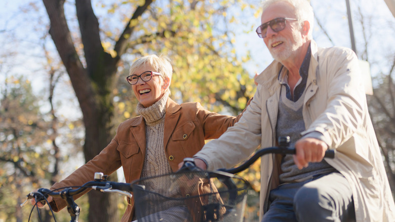 elderly couple riding bikes