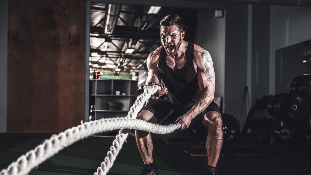 man using battle ropes