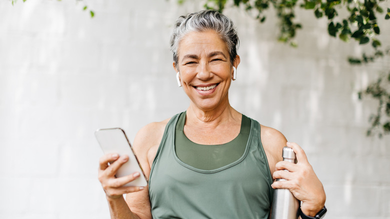 happy healthy woman with water bottle