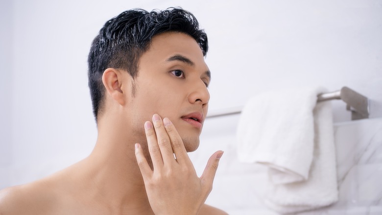 Man looking in mirror after shaving