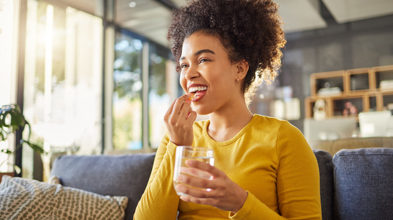 woman taking a vitamin supplement