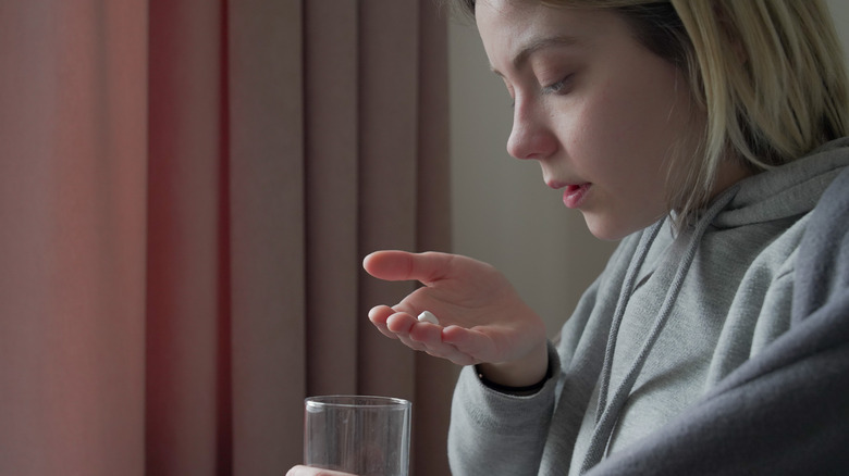 Girl holding a pill