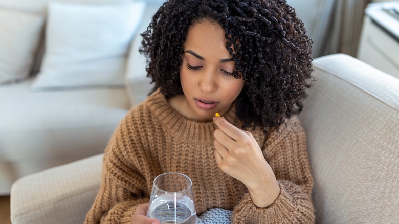 A woman takes birth control pills