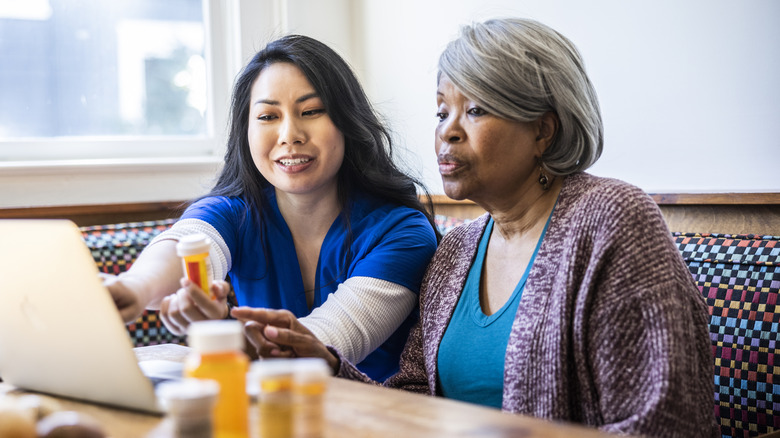 nurse teaching woman about drug interactions