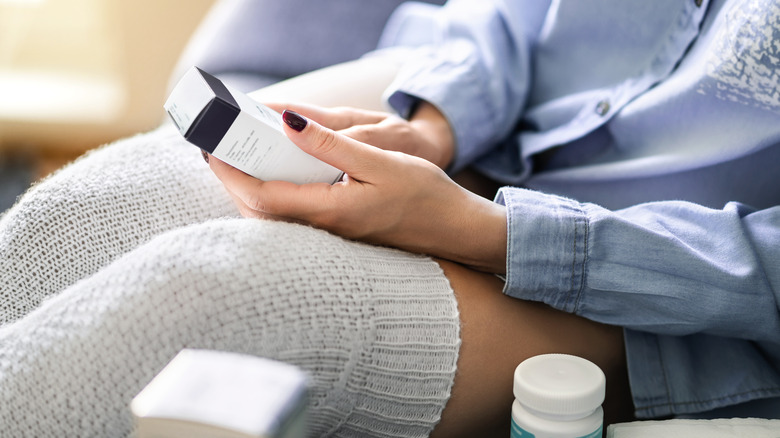 woman holding ibuprofen 