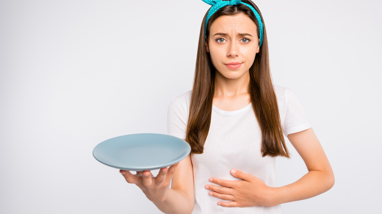 Woman holding an empty plate
