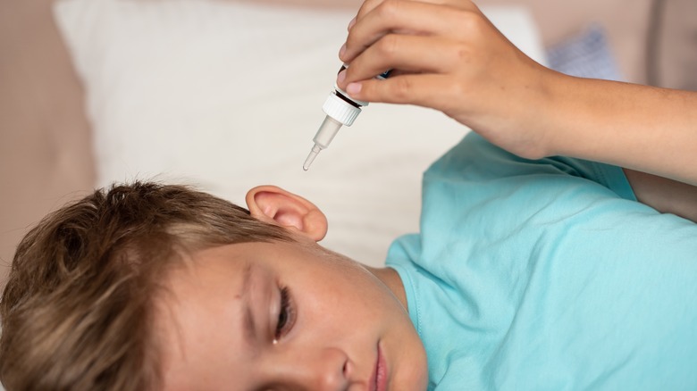 young child getting ear drops