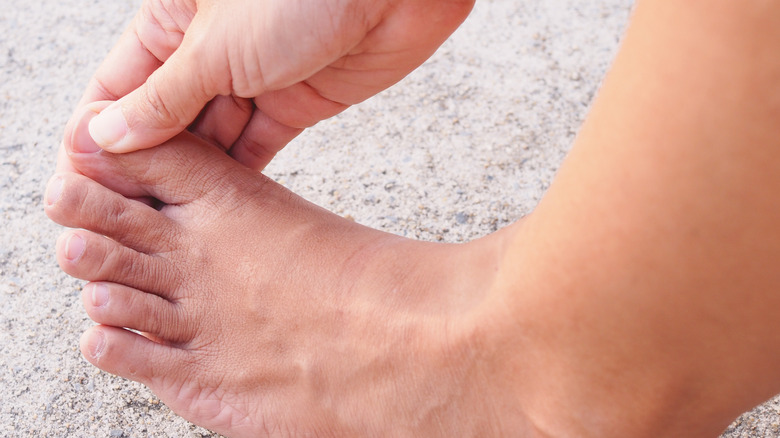 Hand inspecting toenails
