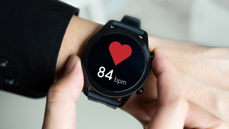 A smartwatch displaying heart rate