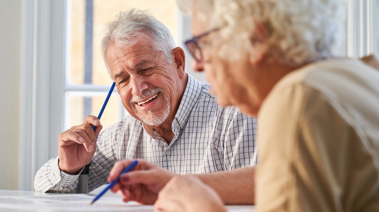 older man and woman working on a puzzle
