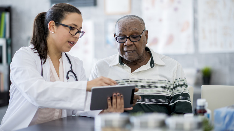 Doctor reviewing chart with patient