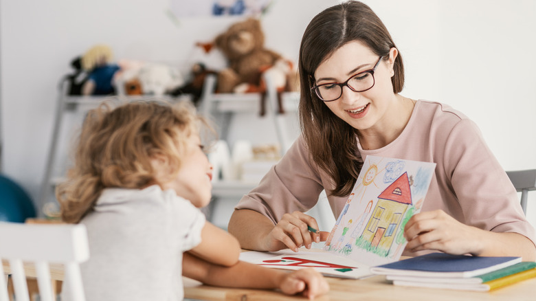Child drawing with therapist