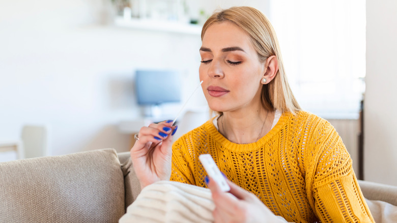 woman using covid test