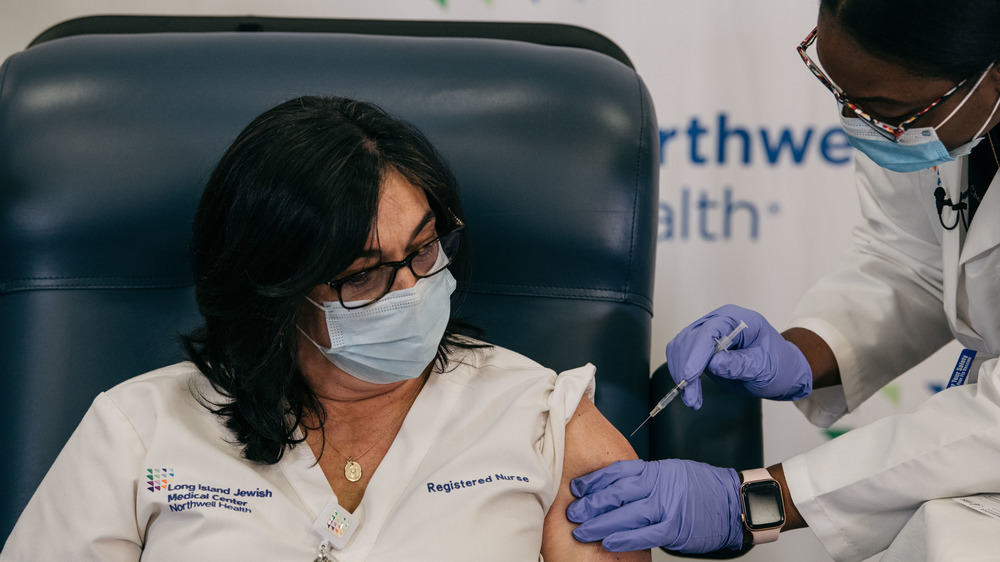 nurse getting COVID vaccine