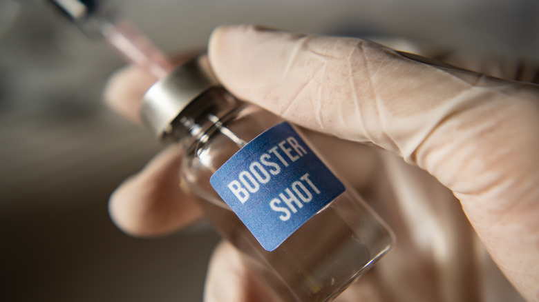 Hand holding booster shot