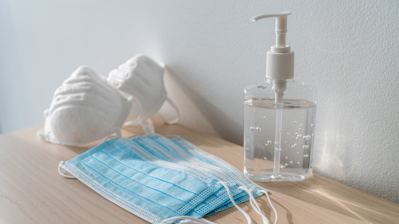 set of COVID masks and hand sanitizer on a table