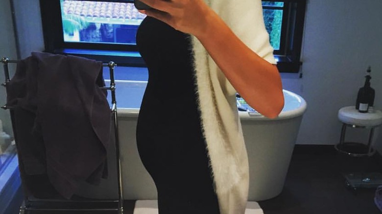 A selfie of Chrissy Teigen's baby bump