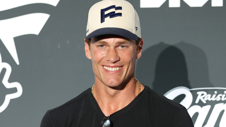 Tom Brady smiling for the camera at an event