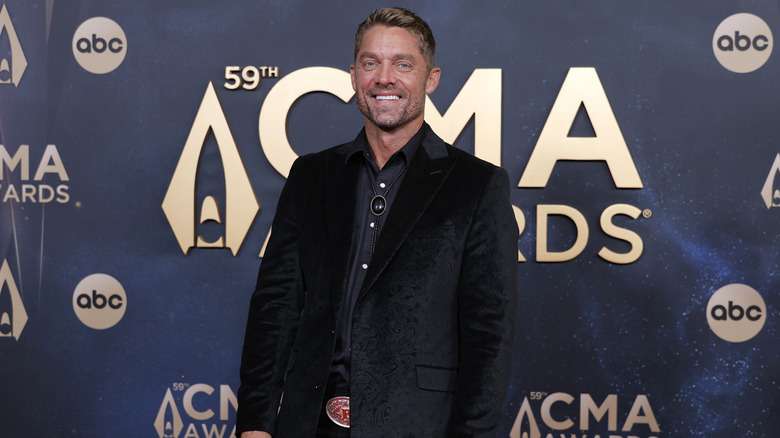 Brett Young posing in a suit