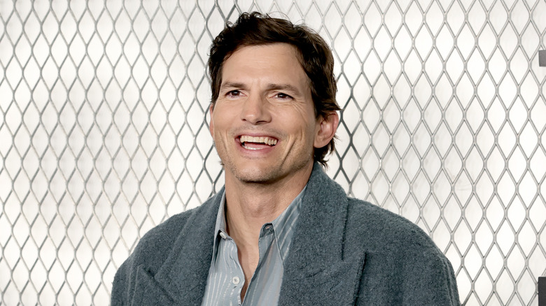 Ashton Kutcher smiling at a celeb event