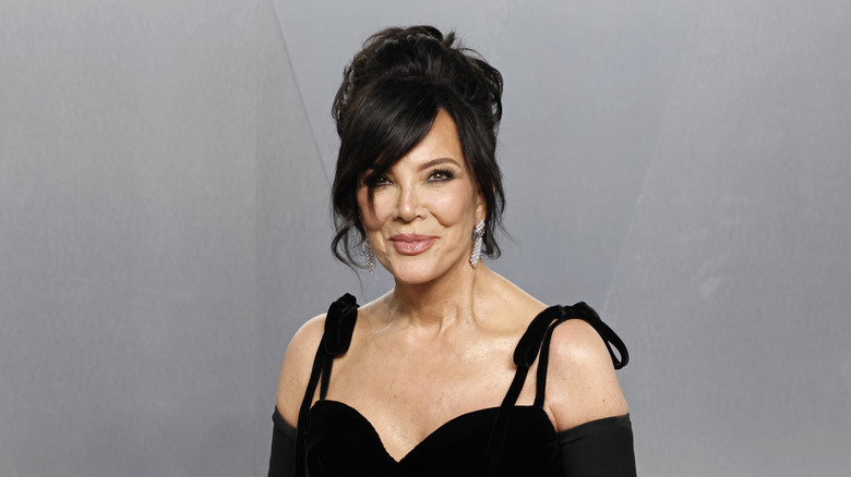 Kris Jenner posing in a black outfit