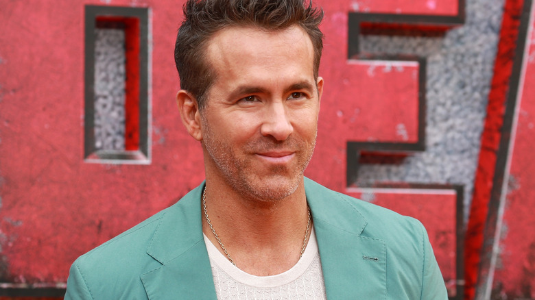Ryan Reynolds standing on the red carpet for the premiere of "Deadpool and Wolverine"