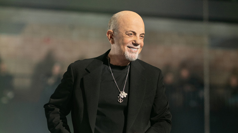 Musician Billy Joel smiling while on stage