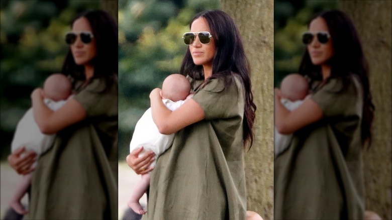 Meghan Markle holding Archie while attending the King Power Royal Charity Polo Match