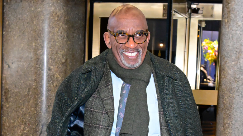 Al Roke bundled up in coats, smiling while looking off to the right.