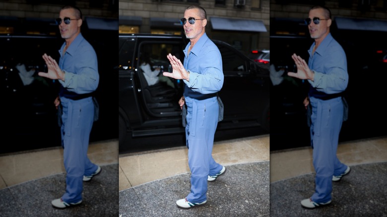 Brad Pitt talking to reporters before hopping into a car in Midtown