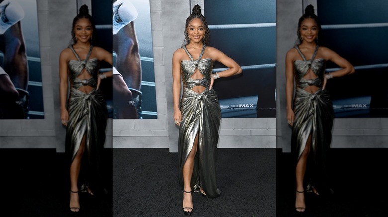 Marsai Martin smiling at a celebrity event while wearing a long silver gown